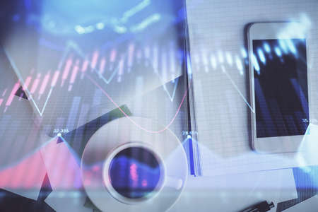Multi exposure of forex graph hologram over desktop with phone. Top view. Mobile trade platform...