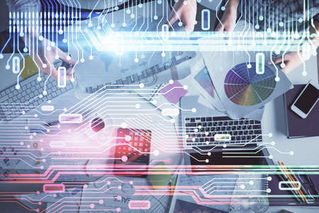 Double exposure of man and woman working together and data theme hologram drawing. Computer...