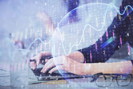 Multi exposure of woman hands typing on computer and financial graph hologram drawing. Stock market...