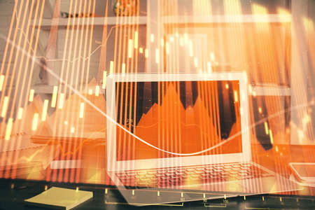 Forex market graph hologram and personal computer on background. Multi exposure. Concept of...