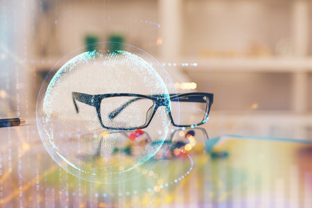 Map hologram with glasses on the table background. Concept of globalization. Double exposure.の写真素材