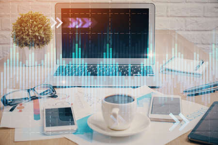 Forex market graph hologram and personal computer on background. Multi exposure. Concept of investment.の写真素材