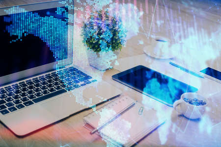 Forex market graph hologram and personal computer on background. Multi exposure. Concept of...