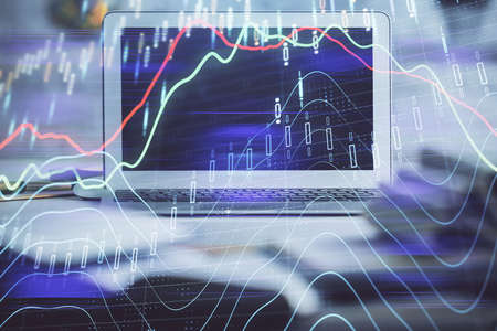 Forex market graph hologram and personal computer on background. Multi exposure. Concept of...