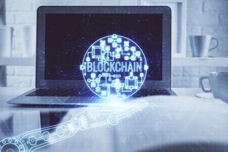 Multi exposure of blockchain theme hologram and table with computer background. Concept of bitcoin...