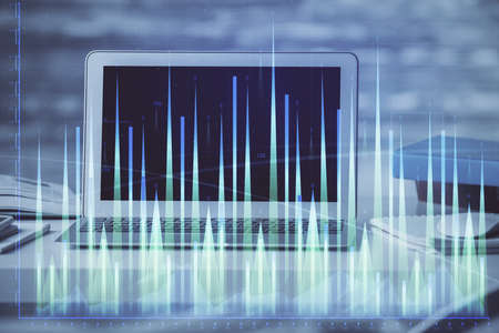 Forex market graph hologram and personal computer on background. Double exposure. Concept of...