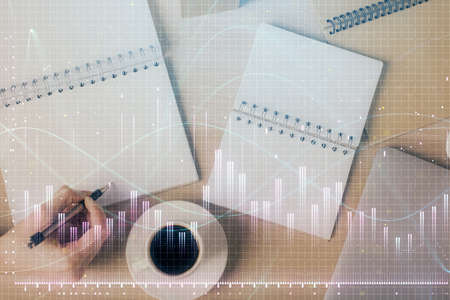 Multi exposure of woman's hands making notes with forex graph hologram. Concept of technical...