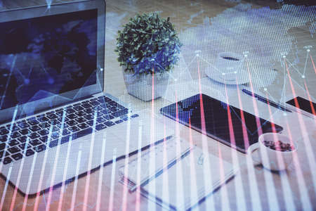 Forex market graph hologram and personal computer on background. Double exposure. Concept of...