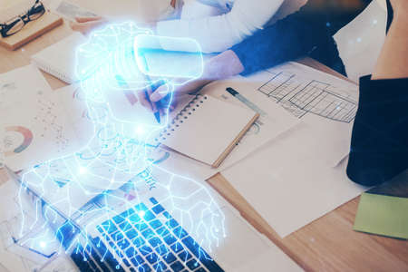 AR hologram over hands taking notes background. Concept of augmented reality. Double exposureの写真素材