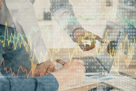 Double exposure of graph with man typing on computer in office on background. Concept of hard work....