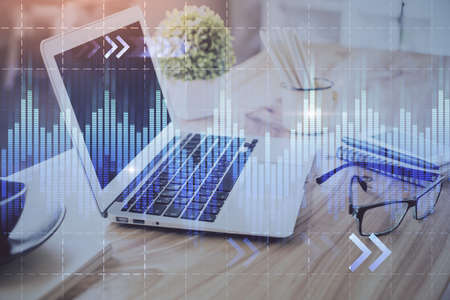 Forex market chart hologram and personal computer background. Multi exposure. Concept of investment.