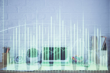 Forex market chart hologram and personal computer background. Multi exposure. Concept of investment.の写真素材