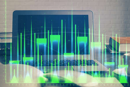 Forex market chart hologram and personal computer background. Multi exposure. Concept of investment.