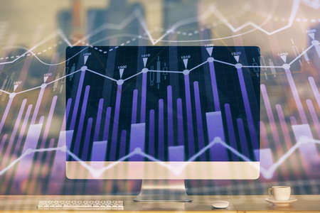 Forex market chart hologram and personal computer background. Multi exposure. Concept of investment.の写真素材