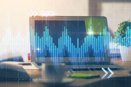 Forex market chart hologram and personal computer background. Multi exposure. Concept of investment.の写真素材