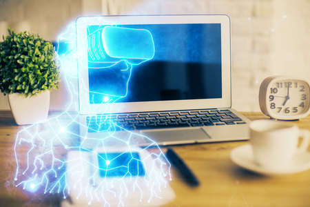 Computer on desktop with AR theme icon. Multi exposure. Concept of augmented reality.
