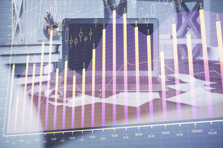 Stock market graph and table with computer background. Multi exposure. Concept of financial...
