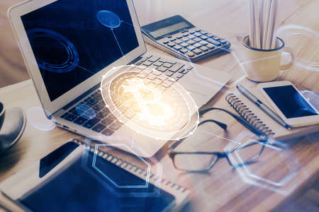 Double exposure of blockchain and crypto economy theme hologram and table with computer background. Concept of bitcoin cryptocurrency.の写真素材