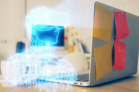 Computer on desktop with AR theme icon. Multi exposure. Concept of augmented reality.の写真素材