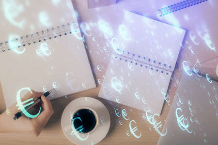 Multi exposure of woman's hands making notes with forex graph hologram. Concept of technical analysis.の写真素材