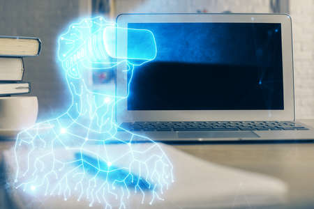 Computer on desktop with AR theme icon. Multi exposure. Concept of augmented reality.の写真素材