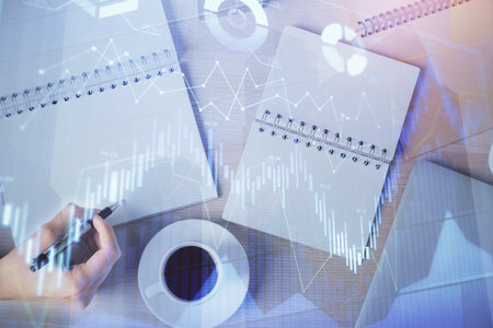Multi exposure of woman's hands making notes with forex graph hologram. Concept of technical analysis.の写真素材