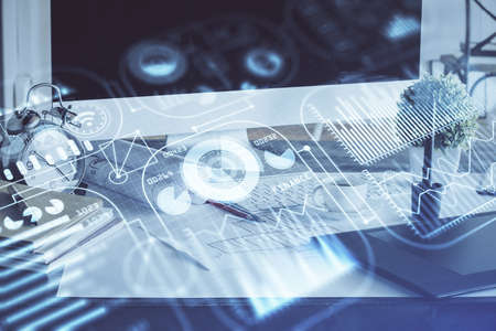 Computer on desktop in office with technology theme hologram. Double exposure. Tech concept.
