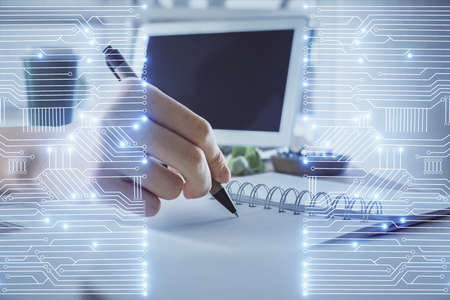 Tech theme hologram over woman's hands taking notes background. Concept of hightech. Double exposureの写真素材