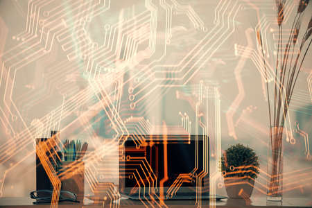 Computer on desktop in office with technology theme hologram. Double exposure. Tech concept.の写真素材