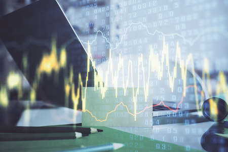 Forex market chart hologram and personal computer background. Double exposure. Concept of...