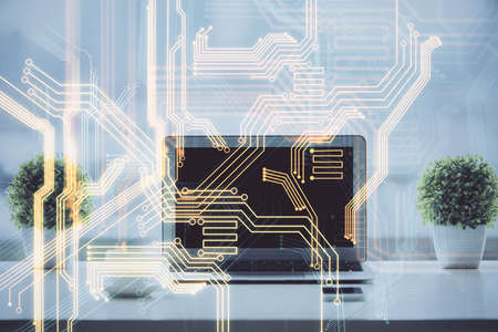 Computer on desktop in office with technology theme hologram. Double exposure. Tech concept.の写真素材