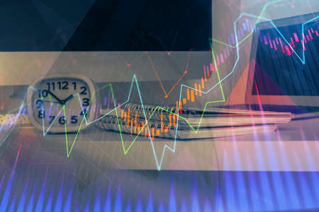 Forex market chart hologram and personal computer background. Double exposure. Concept of...