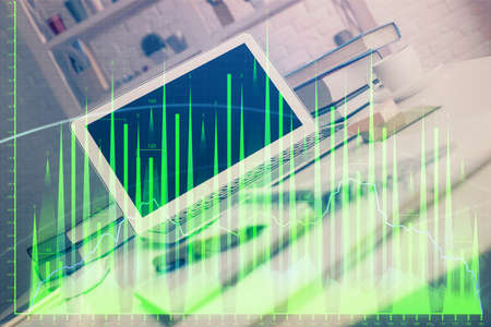 Forex market chart hologram and personal computer background. Double exposure. Concept of...
