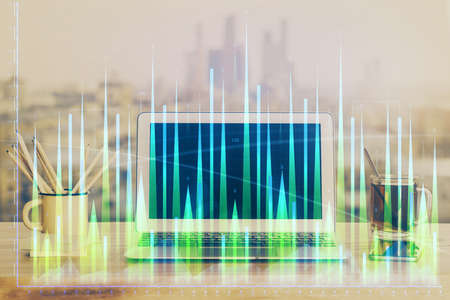 Stock market chart hologram drawn on personal computer background. Multi exposure. Concept of...