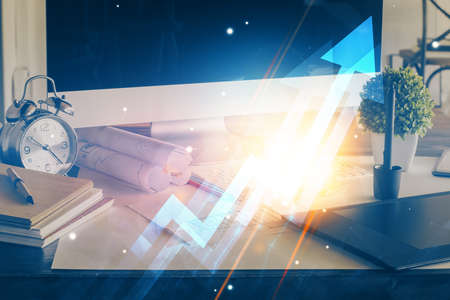 Computer on desktop with point up arrows hologram. Double exposure. Concept of success.の写真素材