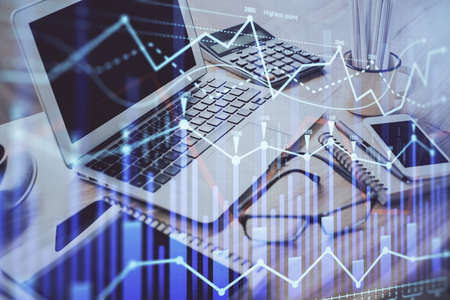 Forex market chart hologram and personal computer background. Double exposure. Concept of...