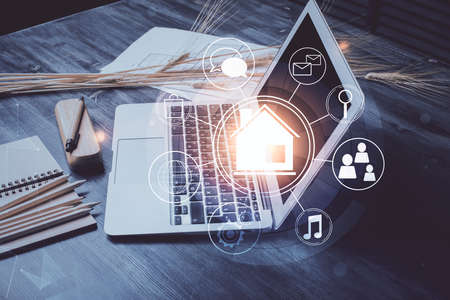 Desktop computer background in office and big town buildings hologram drawing. Double exposure. Smart city concept.の写真素材