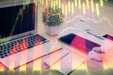 Stock market chart hologram drawn on personal computer background. Multi exposure. Concept of...