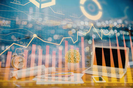 Multi exposure of chart and financial info and work space with computer background. Concept of...