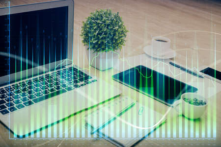 Forex market graph hologram and personal computer on background. Multi exposure. Concept of...