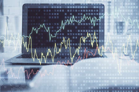 Forex market graph hologram and personal computer on background. Multi exposure. Concept of...