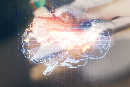 Multi exposure of writing hand on background with brain hologram. Concept of self learning.