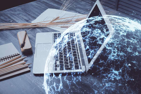 Computer on desktop with social network hologram. Double exposure. Concept of international people connections.の写真素材