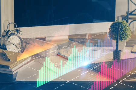 Forex market graph hologram and personal computer on background. Multi exposure. Concept of...