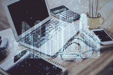 Desktop computer background in office and big town buildings hologram drawing. Double exposure. Smart city concept.の写真素材