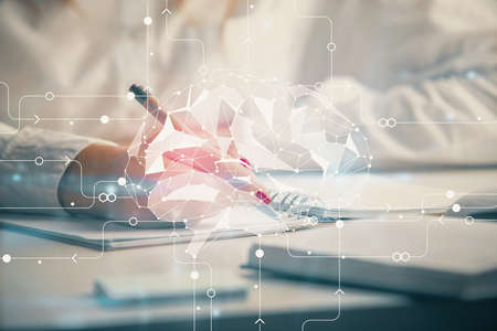 Double exposure of woman's writing hand on background with brain hologram. Concept of brainstorming.