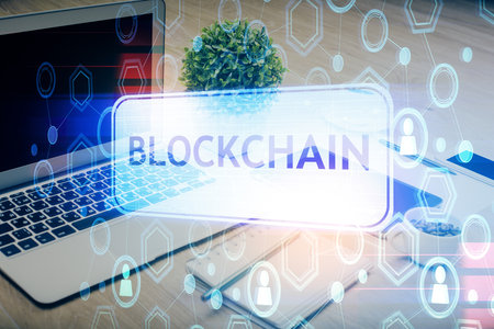 Double exposure of blockchain and crypto economy theme hologram and table with computer background. Concept of bitcoin cryptocurrency.の写真素材