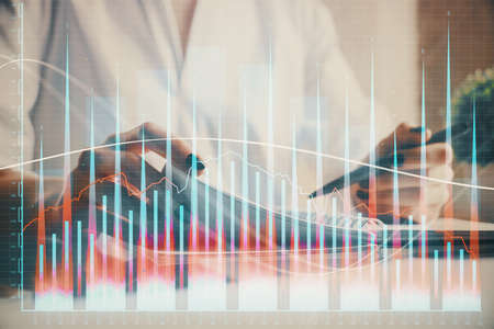 Financial chart drawn over hands taking notes background. Concept of research. Multi exposureの写真素材