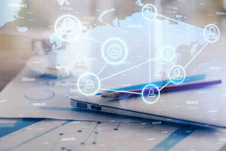Computer on desktop with social network hologram. Double exposure. Concept of international people...