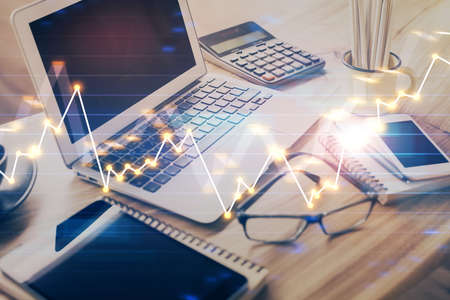 Forex market chart hologram and personal computer background. Multi exposure. Concept of investment.の写真素材